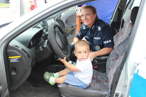 dziecko z policjantką w policyjnym radiowozie