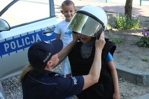 policjantka zakłada dziewczynce kask ochonny