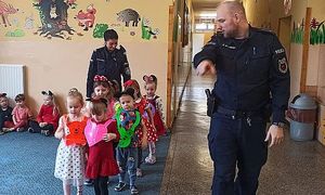 dzieci pod okiem policjantów przechodzą przez przejście